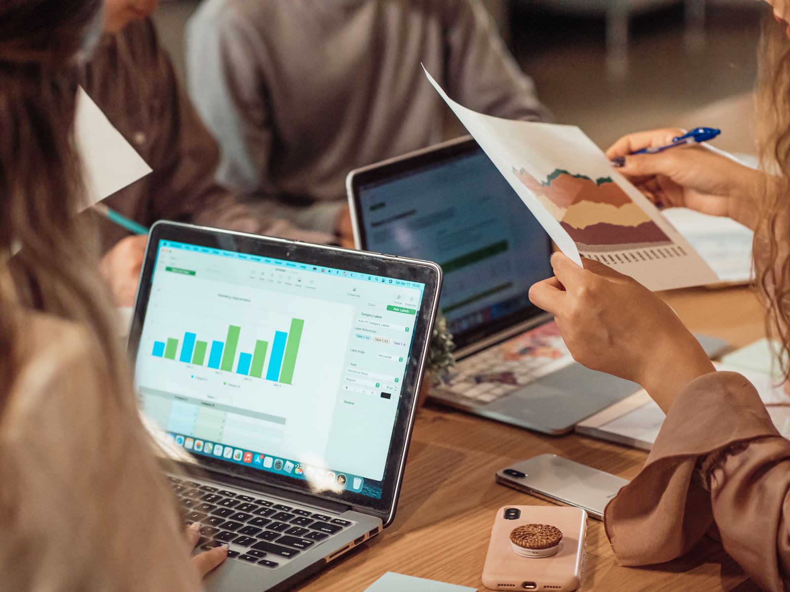 Campaign performance data reviewed on laptops and printed reports